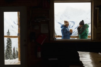 Jessica Baker and Lynn Kennen enjoy tea time on the veranda. Canadian Rockies, Icefall Lodge.