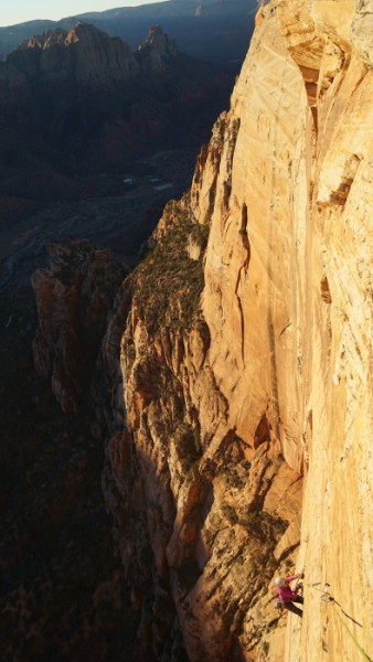 Streaked Wall, Zion National Park, Thanksgiving 2014. This is about hour 22, cleaning the last pitch on the Streaked Wall in Zion National Park. After climbing all night, we were incredibly grateful as sunrise lit up the wall, and even more grateful to know that we were within one pitch of flat rock—where we could finally lay down and take a nap. ​Photo Kyle Dempster