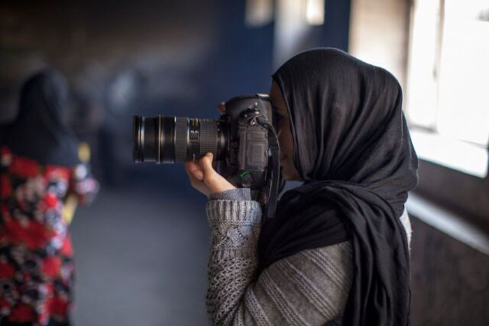 Photographer Farzana Wahidy at work, captured by Alexandria Bombach